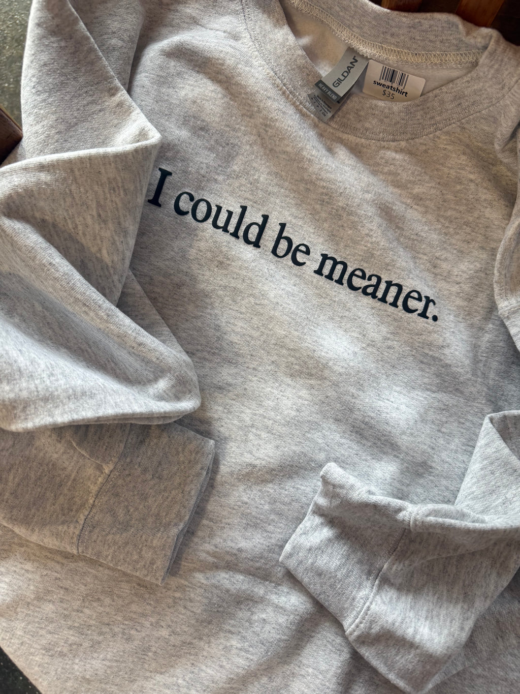 Gray shirt with 'I could be meaner.' text on a plain background