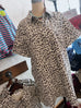 Leopard print shirt on a mannequin against a clothing store background
